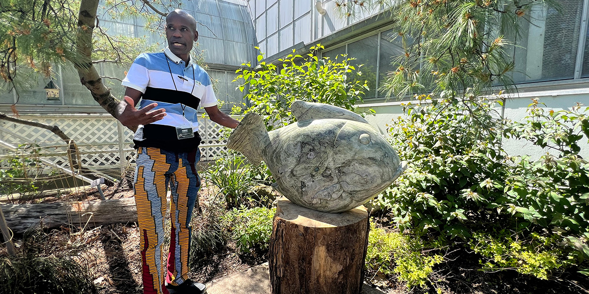 Dominic Benhura gives a tour of sculptures at Krohn Conservatory