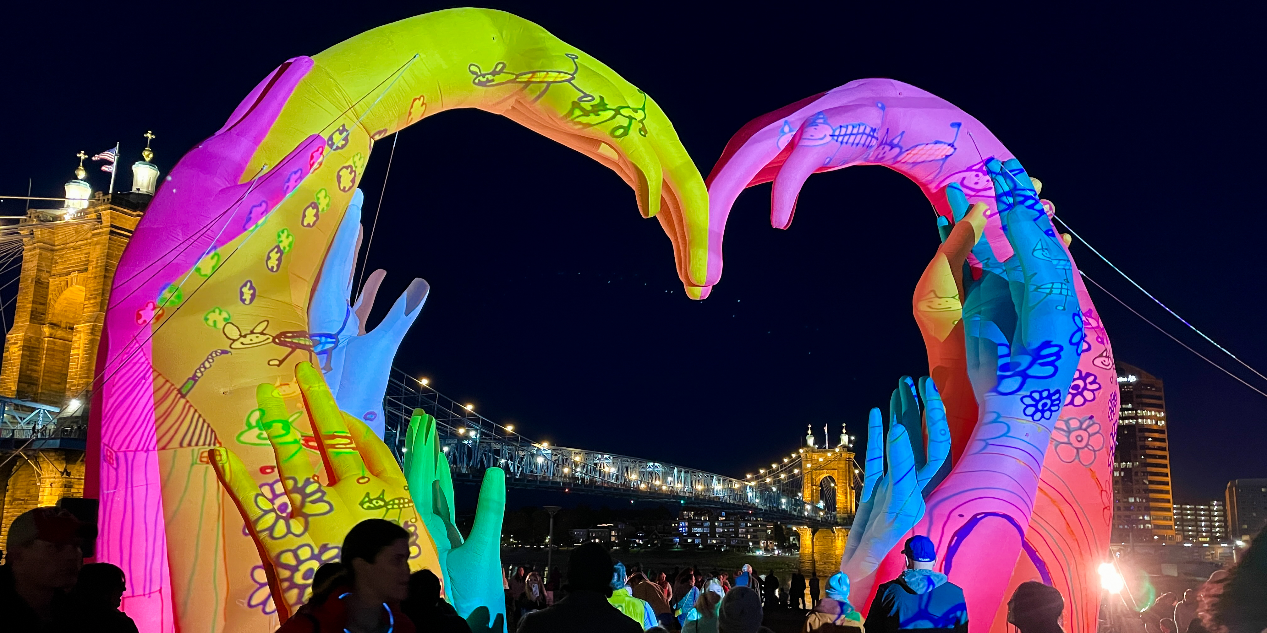 Light sculpture in the shape of a heart with pink, blue, green and yellow colors