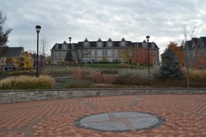 small park with view of lamp posts, plaza, large house and green space