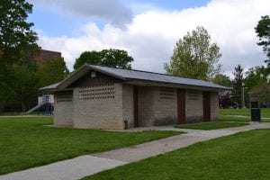 park with large lawn, facility and playground in back