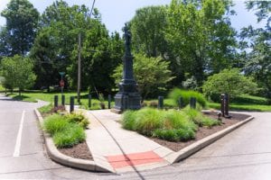 tiny triangular park with statue in the middle