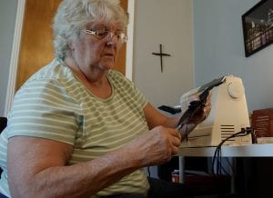 Cincinnati Parks volunteer Jean at sewing machine making masks for staff