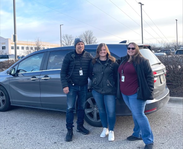 ARC team members standing in front of their van